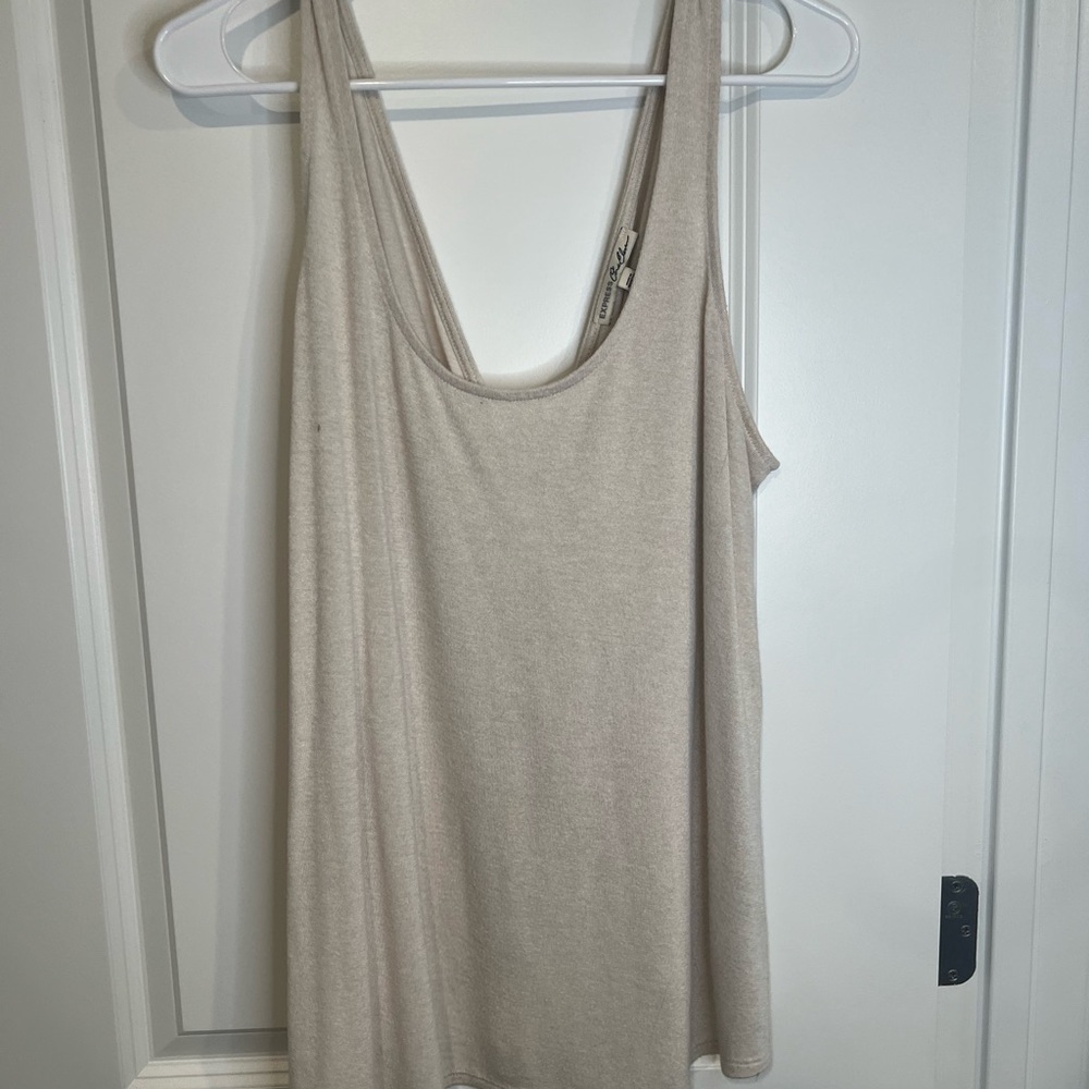 Express size large. Cream twist back/open back tank top.
